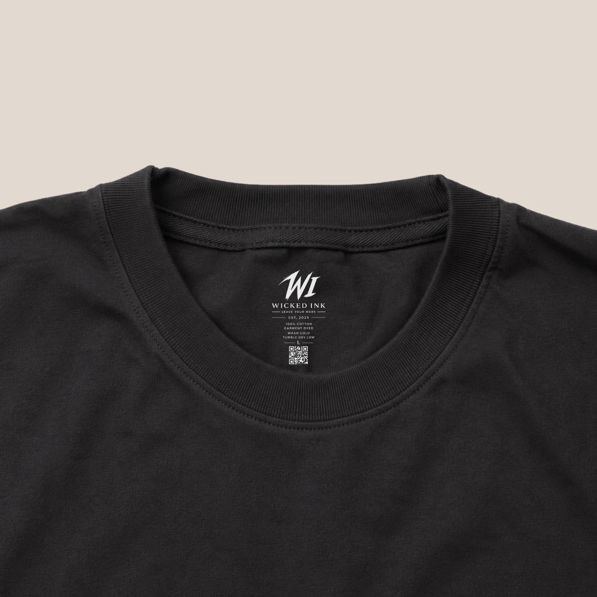 Close-up of a black t-shirt with 'Wicked Ink' branding on the collar.